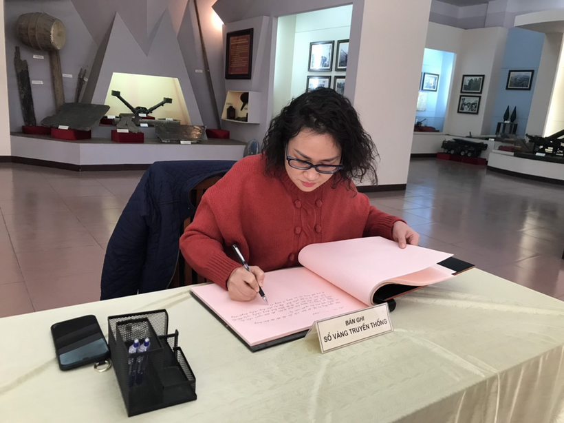 A person writing on a piece of paper

Description automatically generated