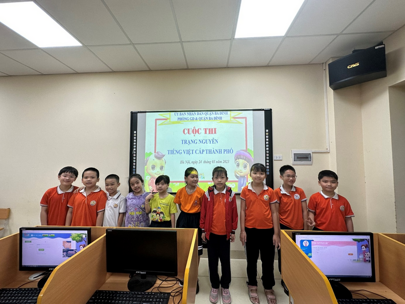 A group of people in orange shirts standing in front of a projector screen

Description automatically generated with low confidence
