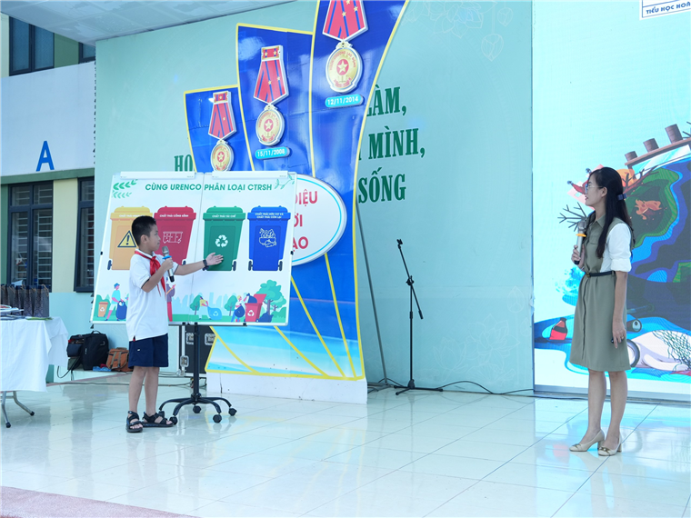 A group of people standing in front of a stageDescription automatically generated