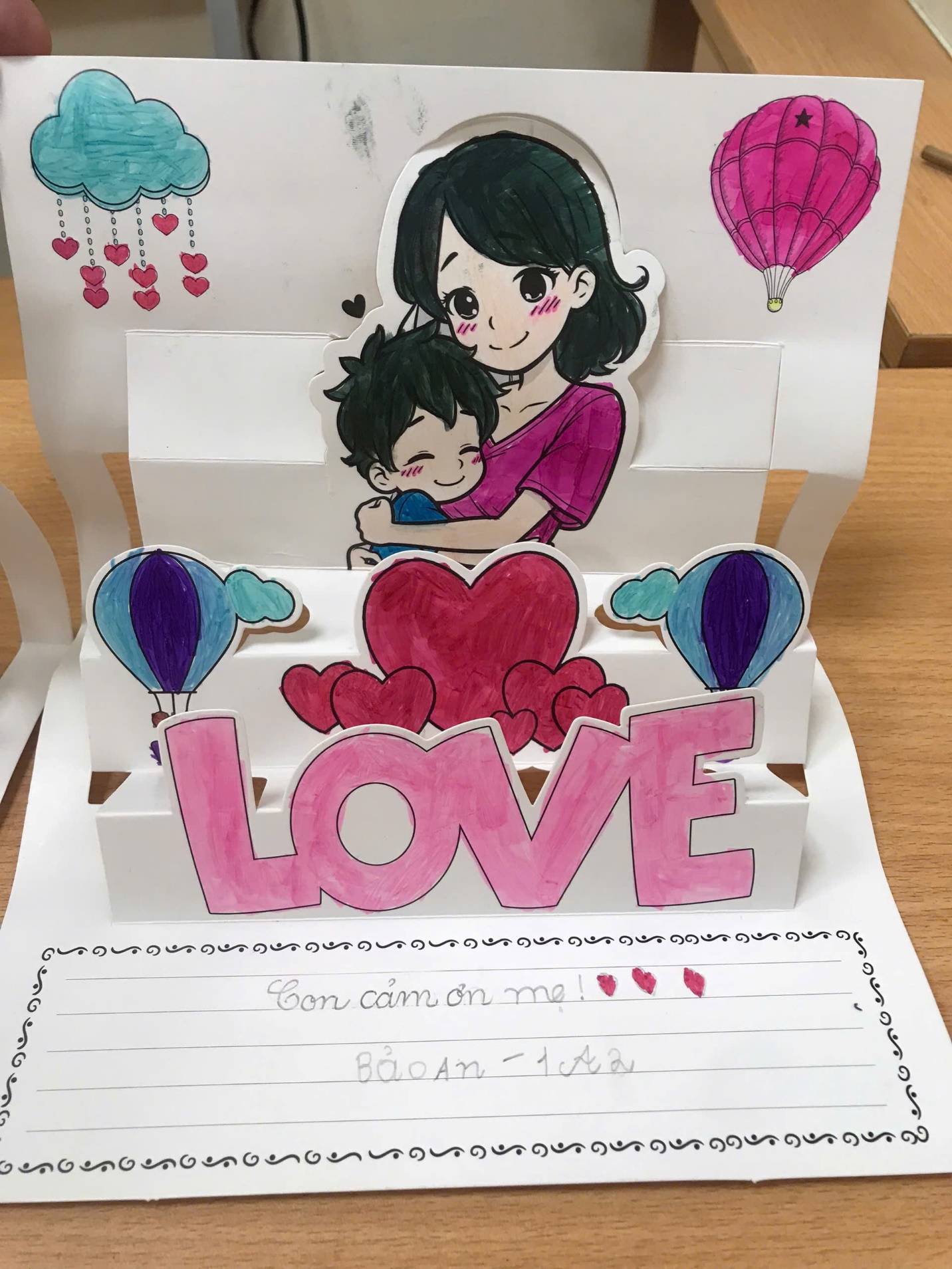A paper with a drawing of a person and a childDescription automatically generated