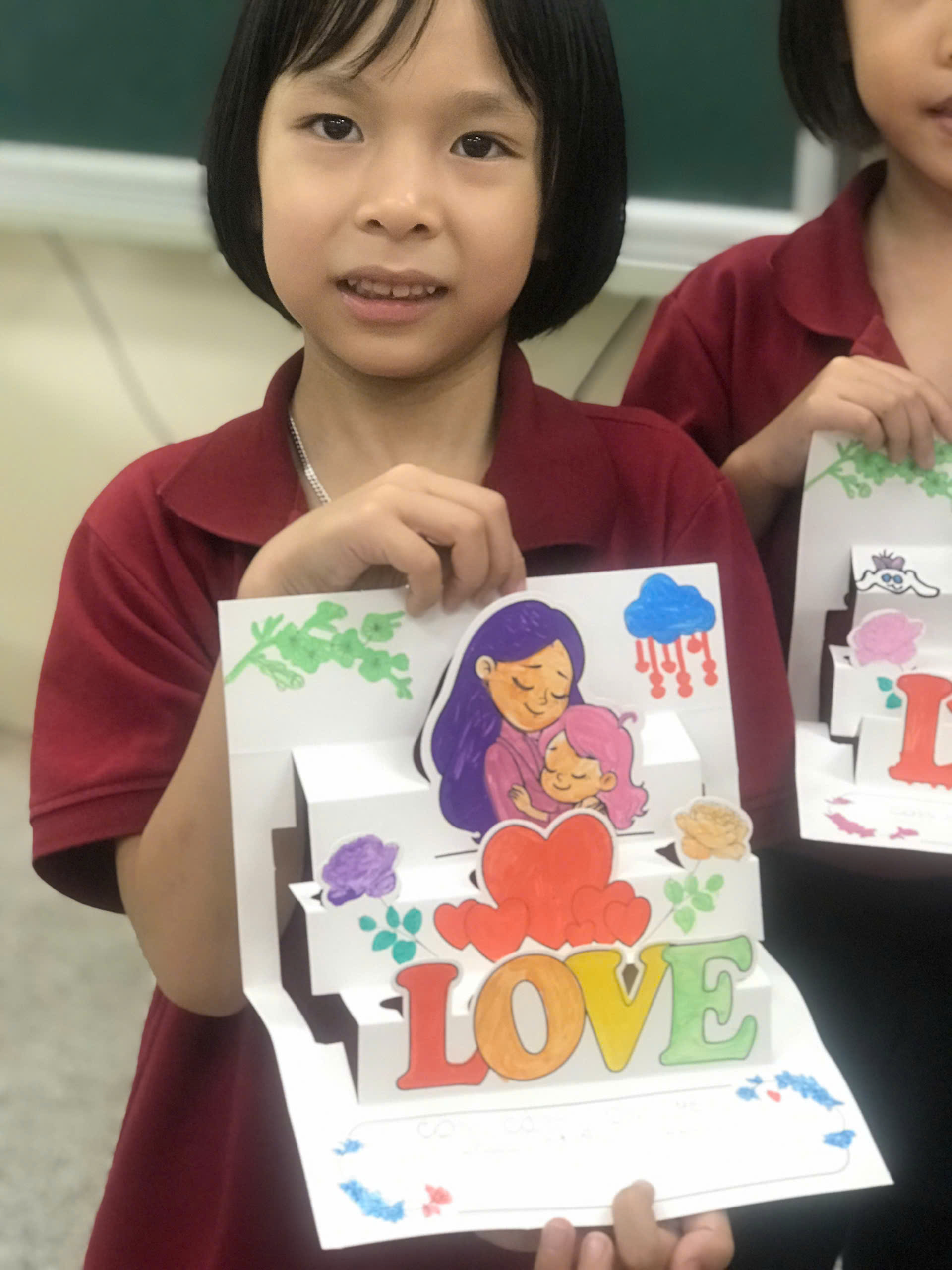 A child holding a box of artDescription automatically generated