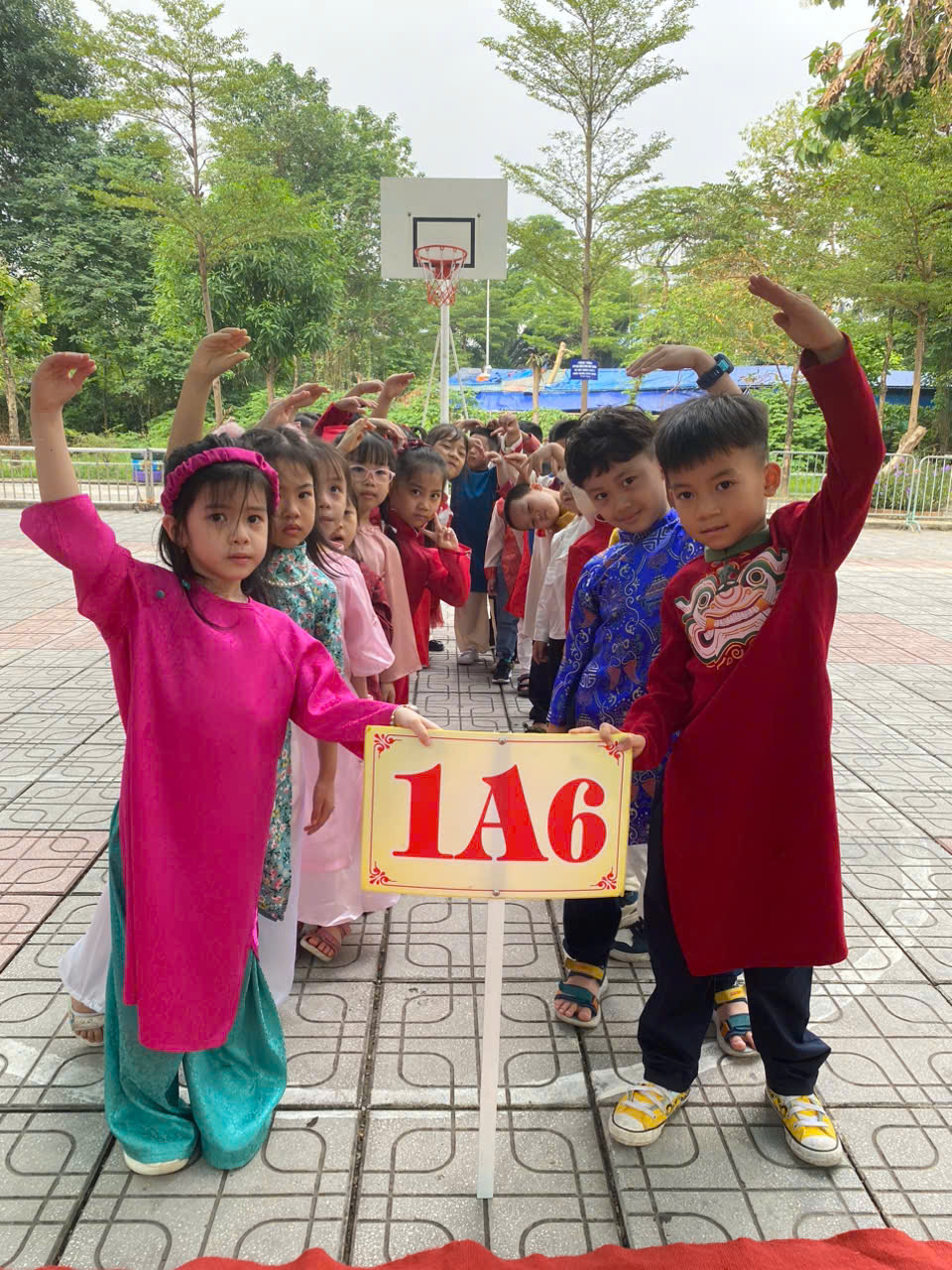 A group of children holding up a signDescription automatically generated