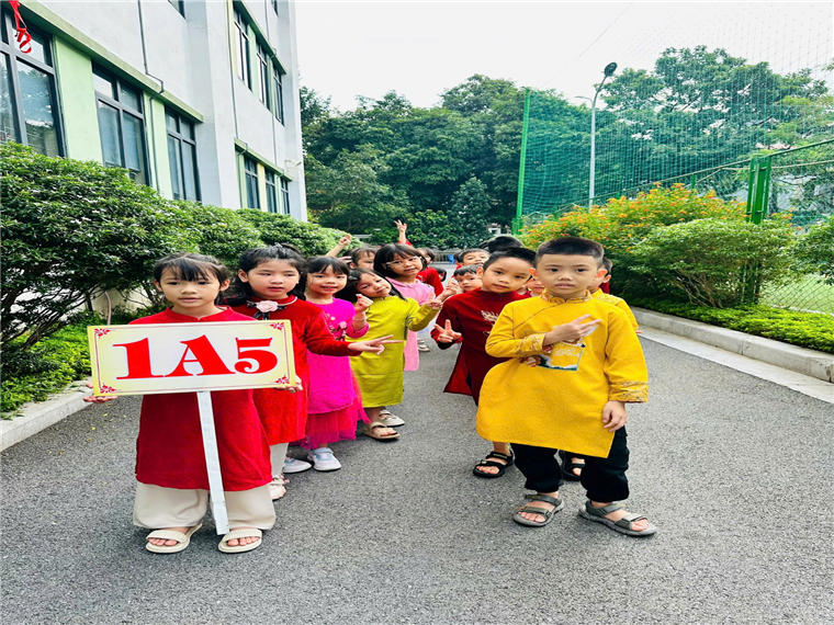 A group of children holding a signDescription automatically generated