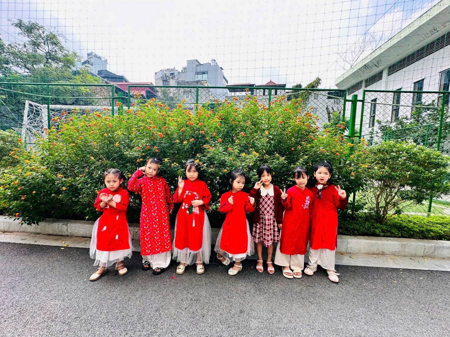 A group of children in red dresses
Description automatically generated