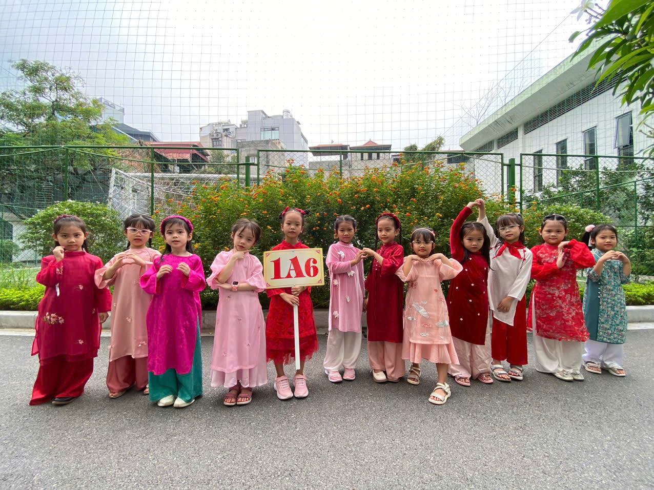 A group of children standing together holding a signDescription automatically generated