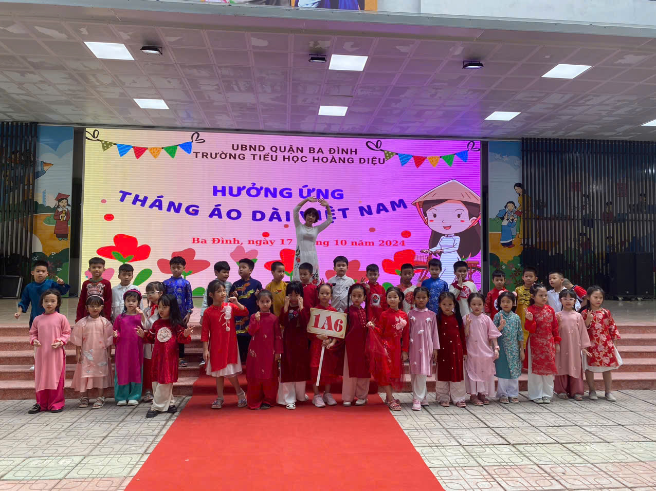 A group of children standing in front of a stageDescription automatically generated