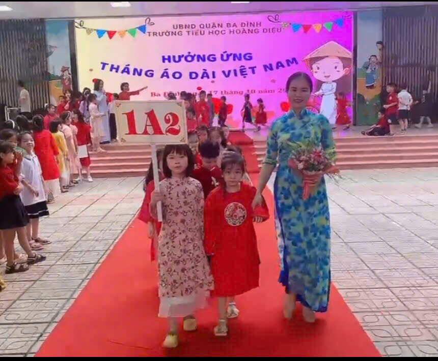 A group of people walking on a red carpetDescription automatically generated