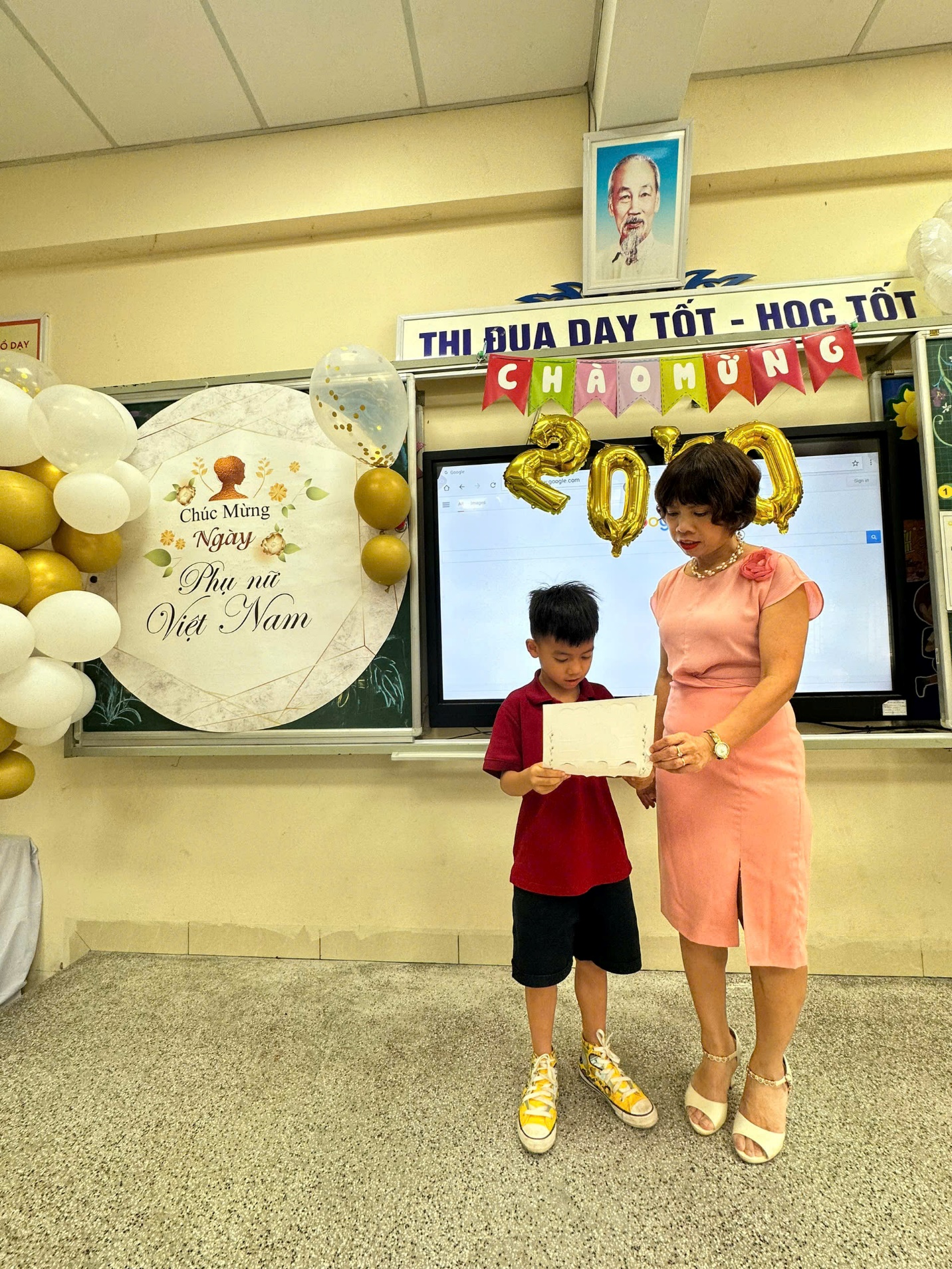 A person and a child holding a signDescription automatically generated