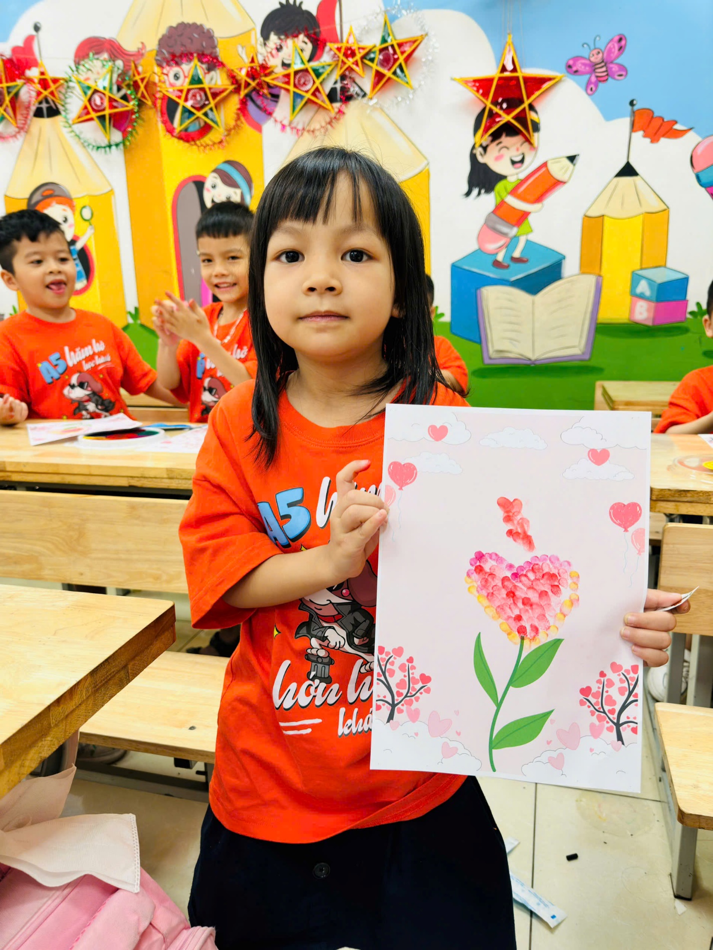 A child holding a piece of paperDescription automatically generated