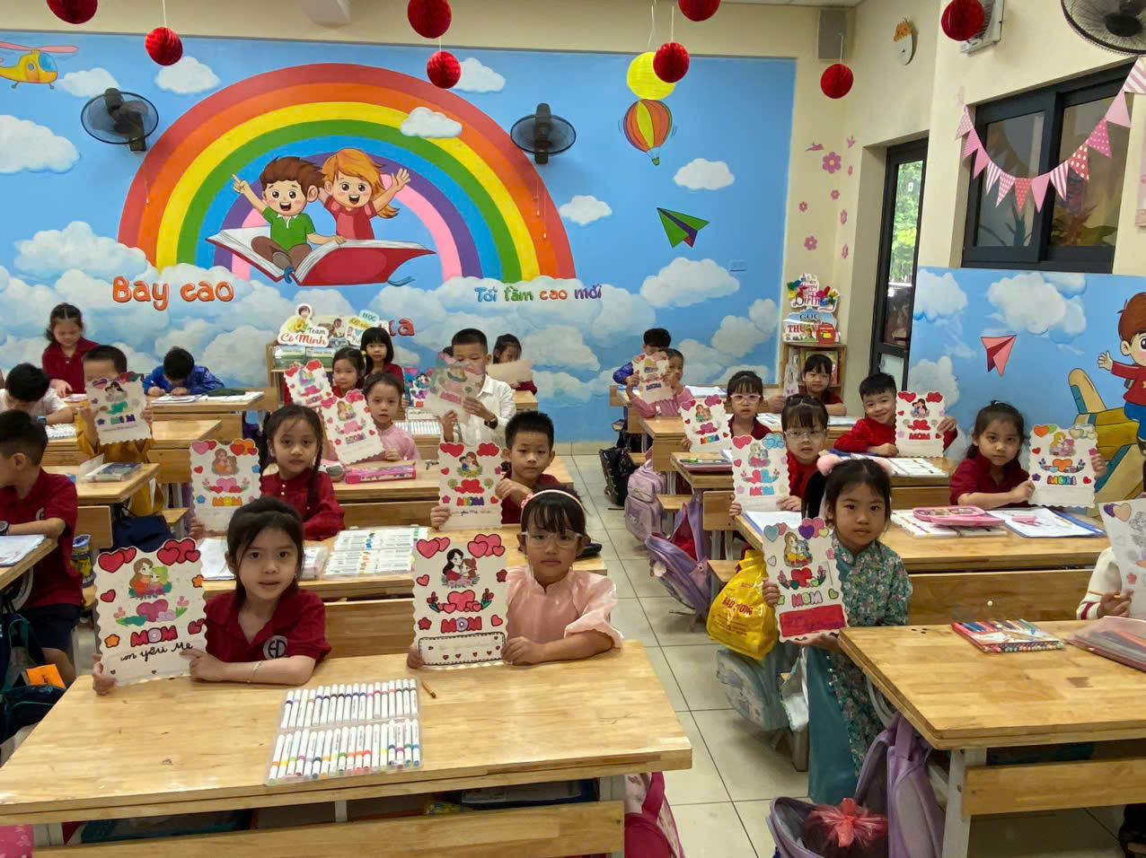 A group of children sitting at desks in a classroomDescription automatically generated