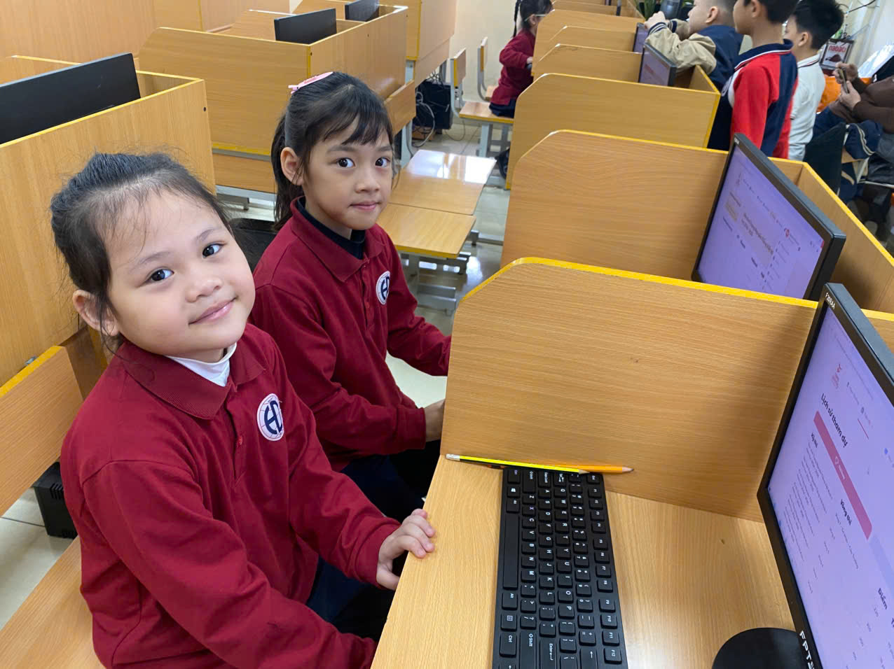 A group of children in a computer labDescription automatically generated