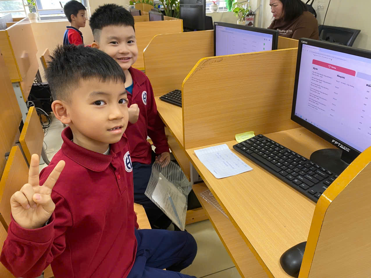 A group of boys in a classroomDescription automatically generated