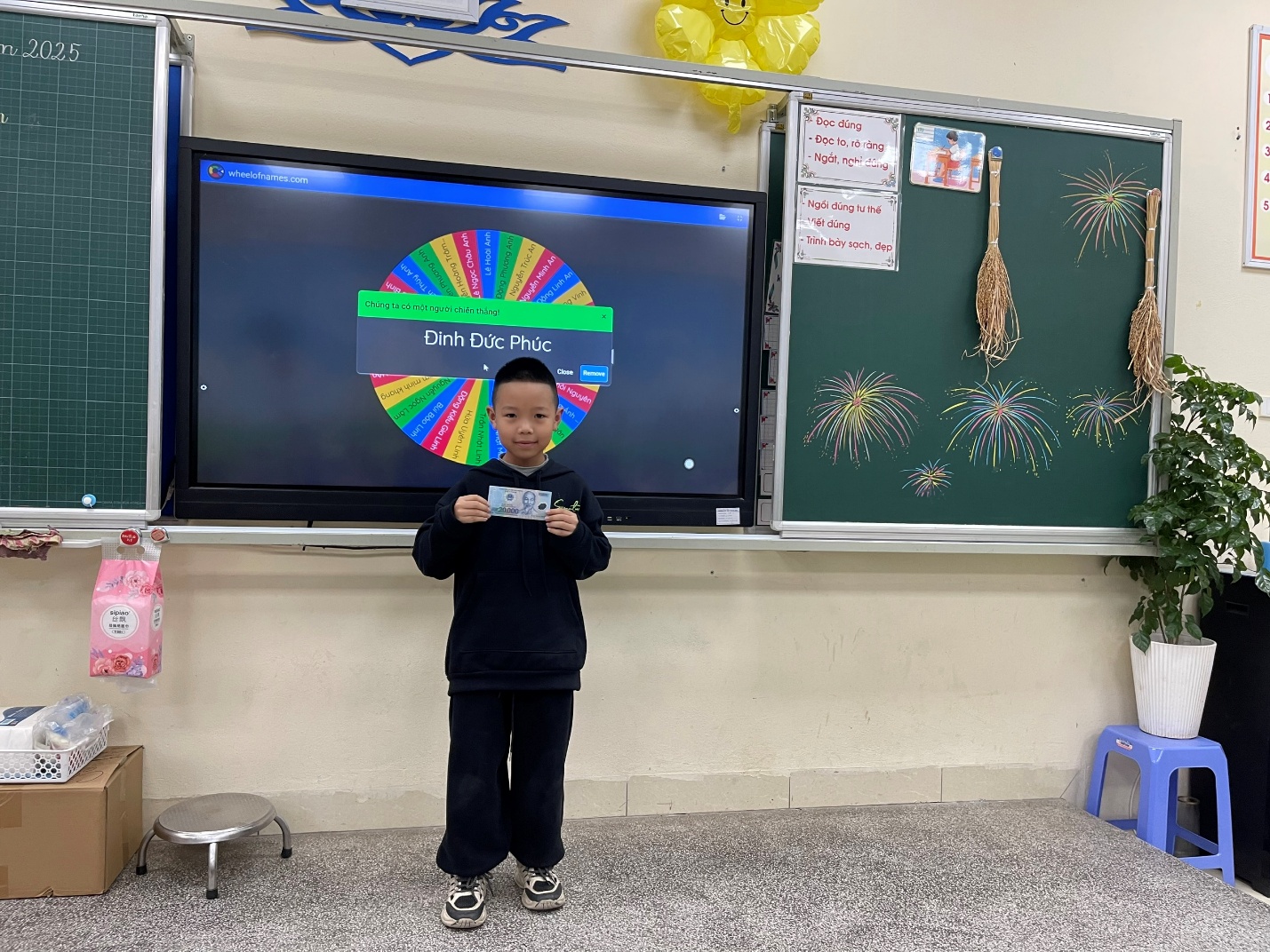 A child standing in front of a televisionDescription automatically generated