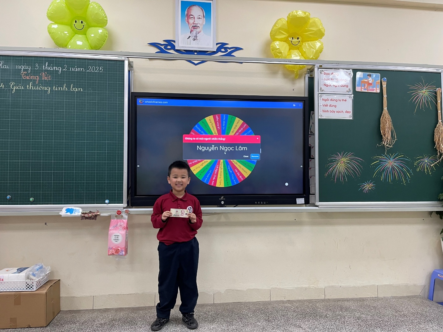 A child standing in front of a large screenDescription automatically generated