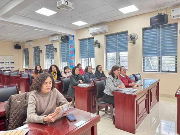 A group of women sitting at desks in a roomAI-generated content may be incorrect.