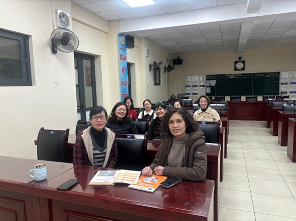 A group of women sitting at a deskAI-generated content may be incorrect.