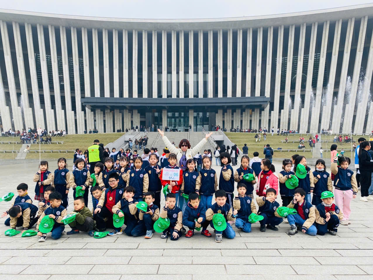 A group of children posing for a photo in front of a buildingAI-generated content may be incorrect.