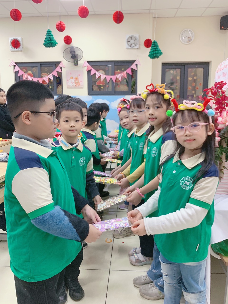 A group of children in green shirtsAI-generated content may be incorrect.