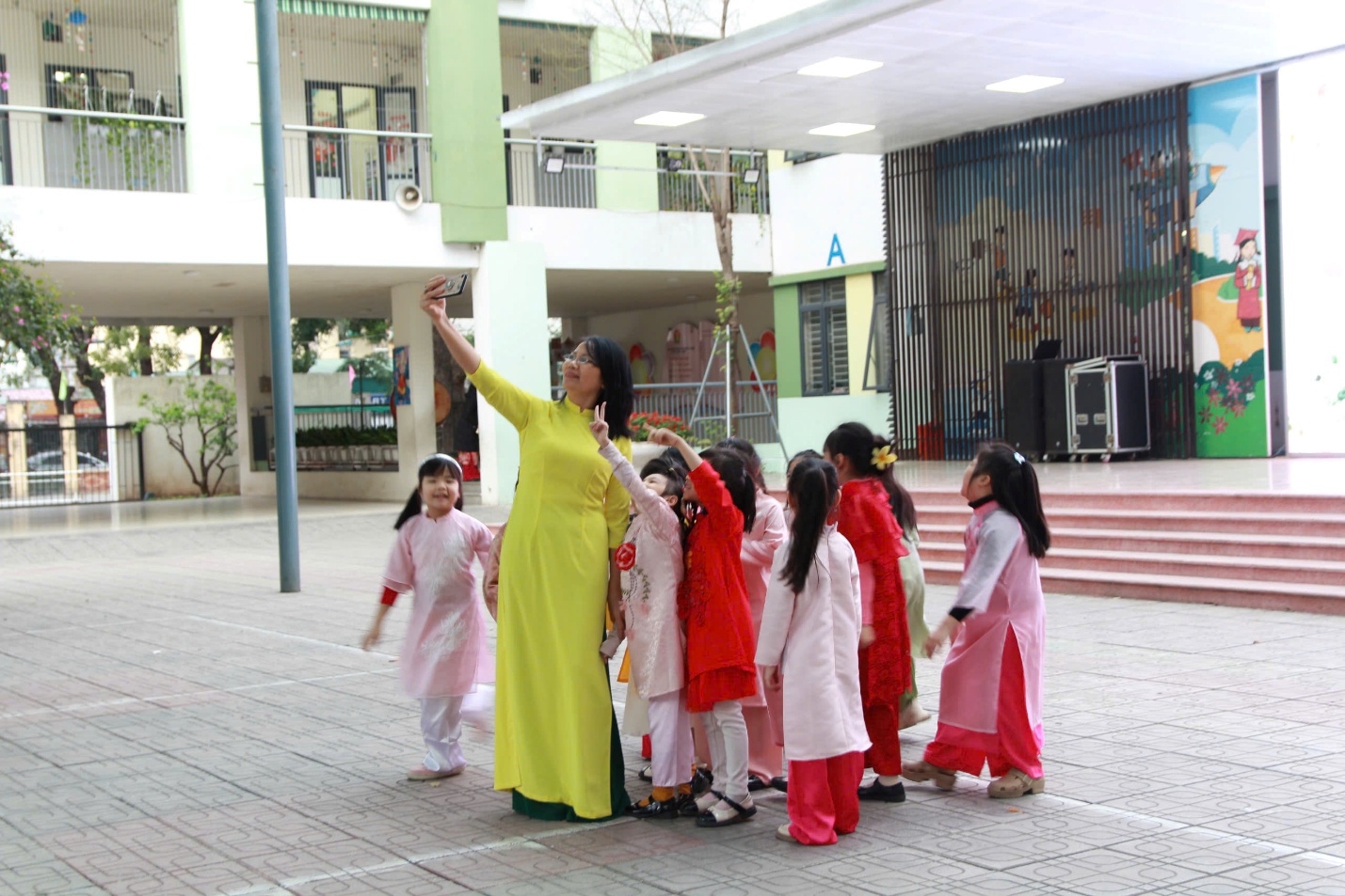 A person taking a selfie with a group of childrenAI-generated content may be incorrect.
