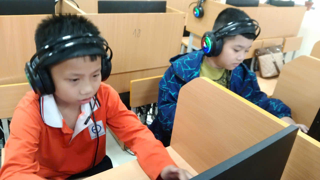 A group of boys wearing headphonesAI-generated content may be incorrect.