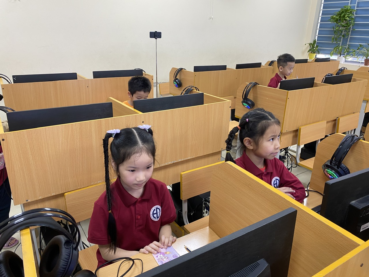 A group of children sitting at desks in a classroomAI-generated content may be incorrect.
