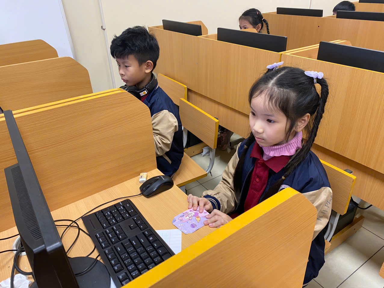 A group of kids sitting at desks in a classroomAI-generated content may be incorrect.