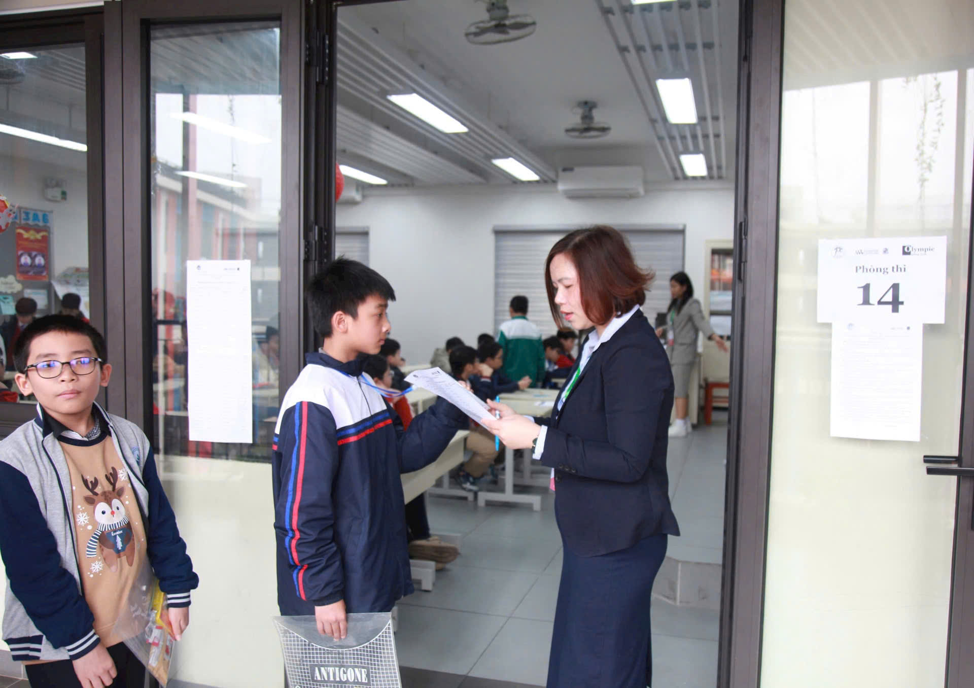 A person handing a paper to a child

Description automatically generated