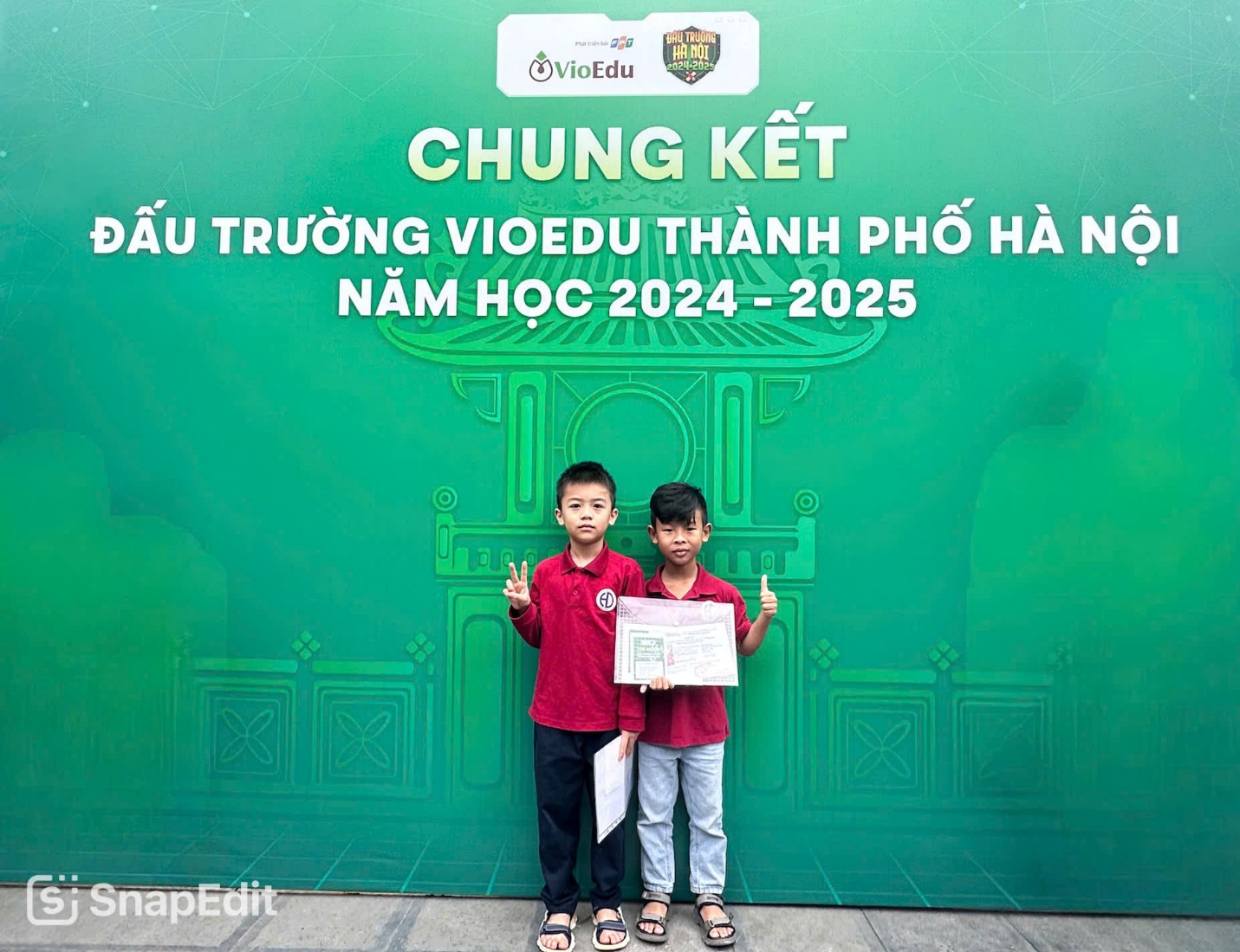 Two boys standing in front of a green signAI-generated content may be incorrect.