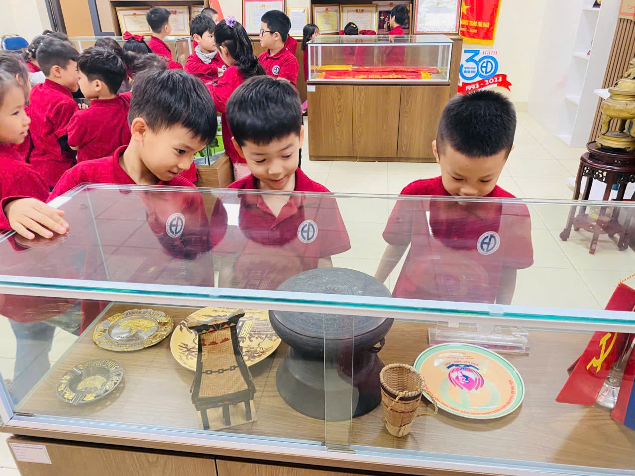 A group of boys looking at a display caseAI-generated content may be incorrect.