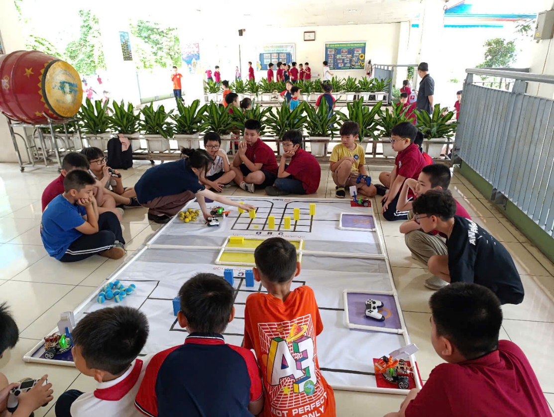 A group of kids sitting on the floor playing a gameAI-generated content may be incorrect.