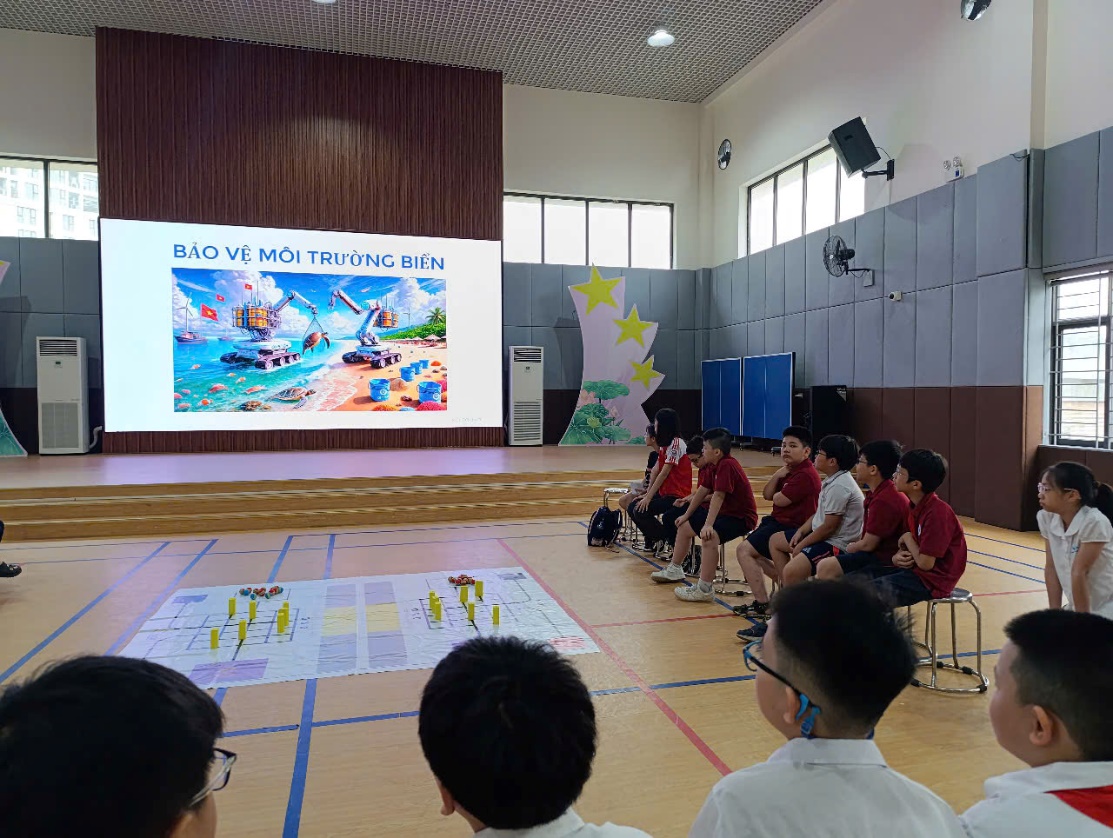 A group of people sitting on a floor in a room with a projector screenAI-generated content may be incorrect.