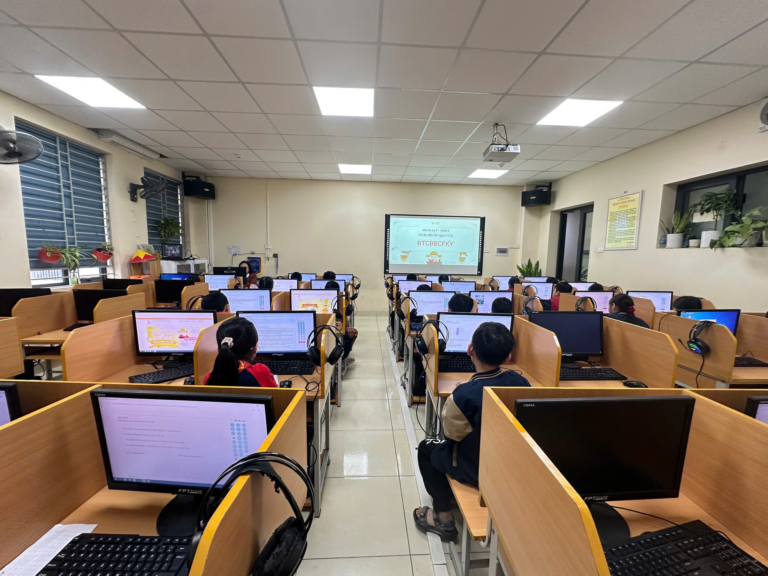 A group of people in a room with computersAI-generated content may be incorrect.