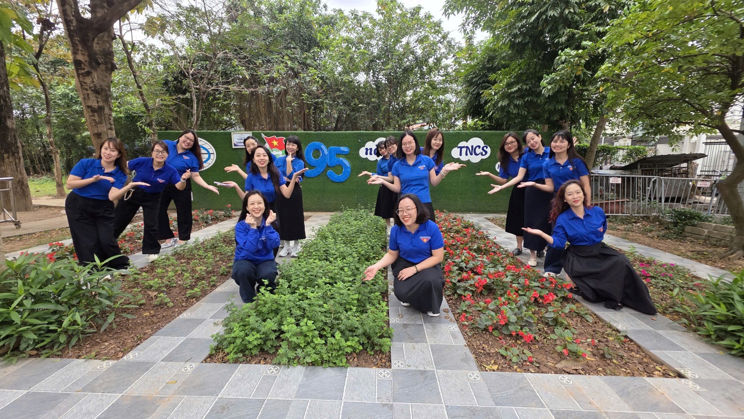 A group of women in blue shirts posing for a picture

AI-generated content may be incorrect.
