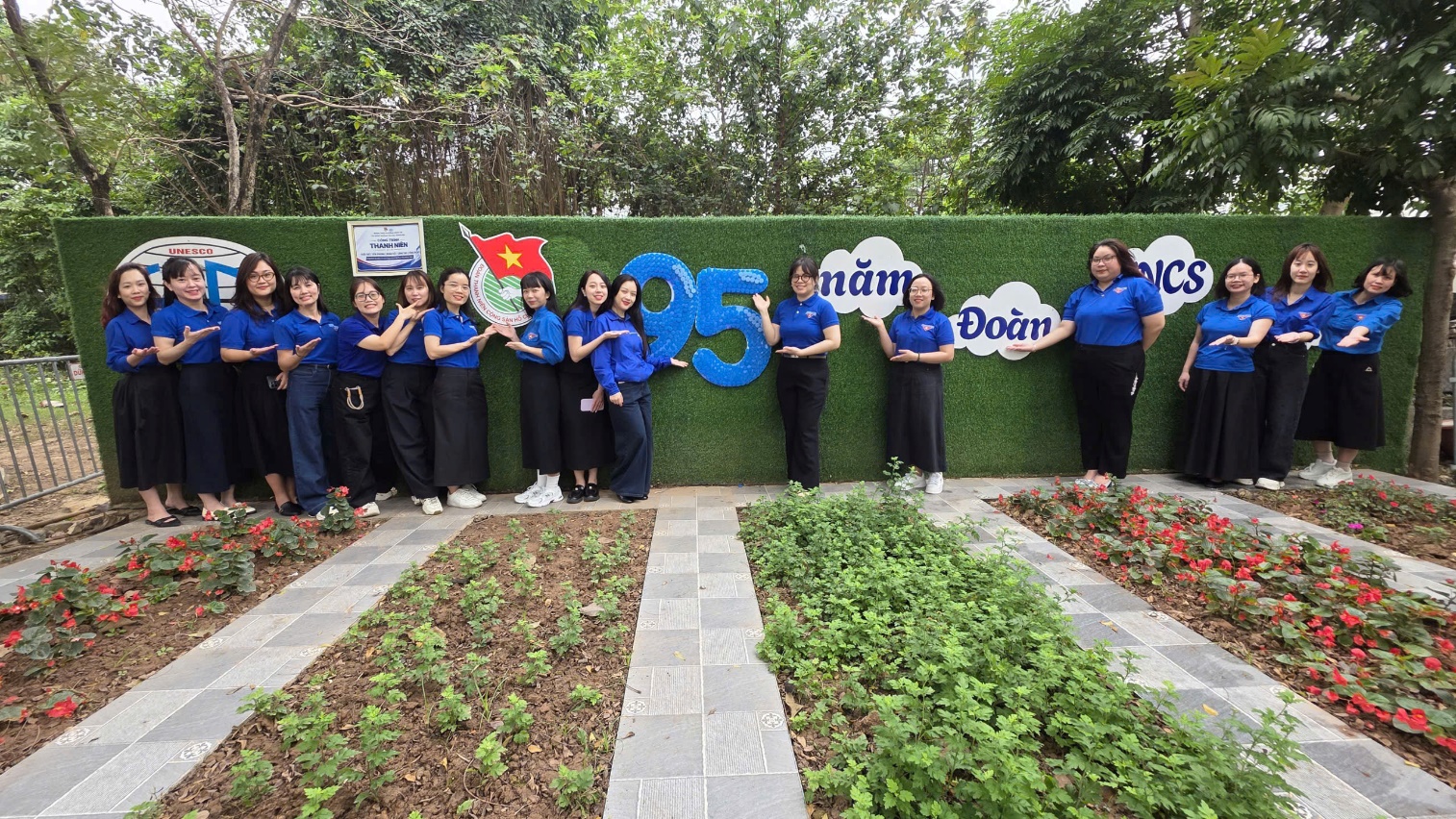 A group of women in blue shirts posing for a photo

AI-generated content may be incorrect.
