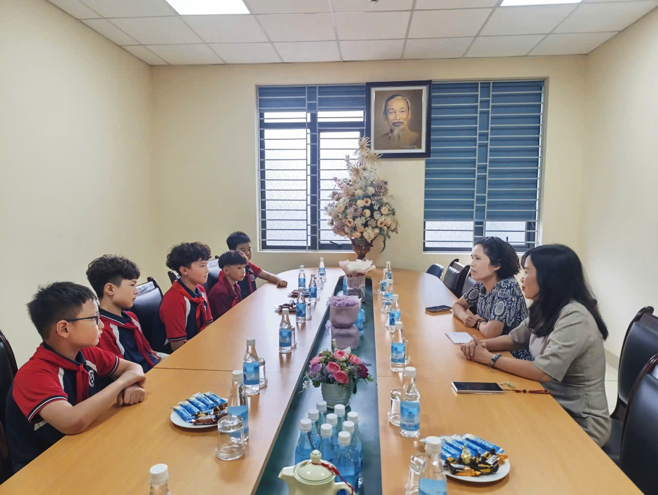 A group of people sitting at a long table

AI-generated content may be incorrect.