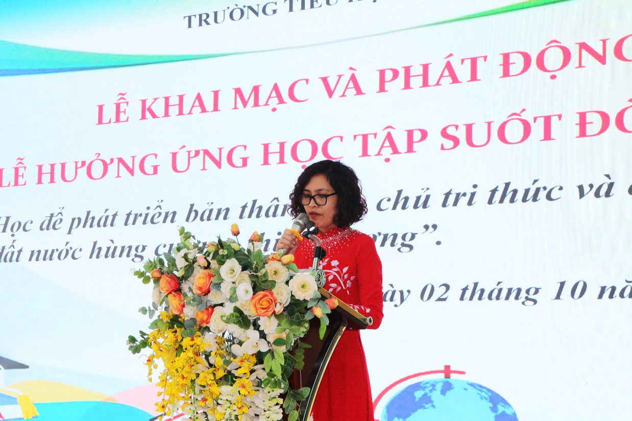 A person standing at a podium with a microphone and flowers

AI-generated content may be incorrect.