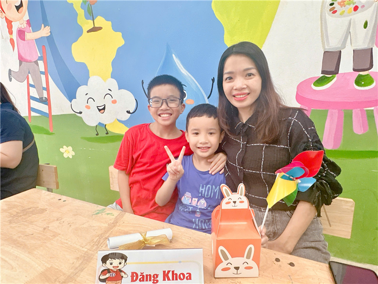 A person and two boys posing for a picture

AI-generated content may be incorrect.