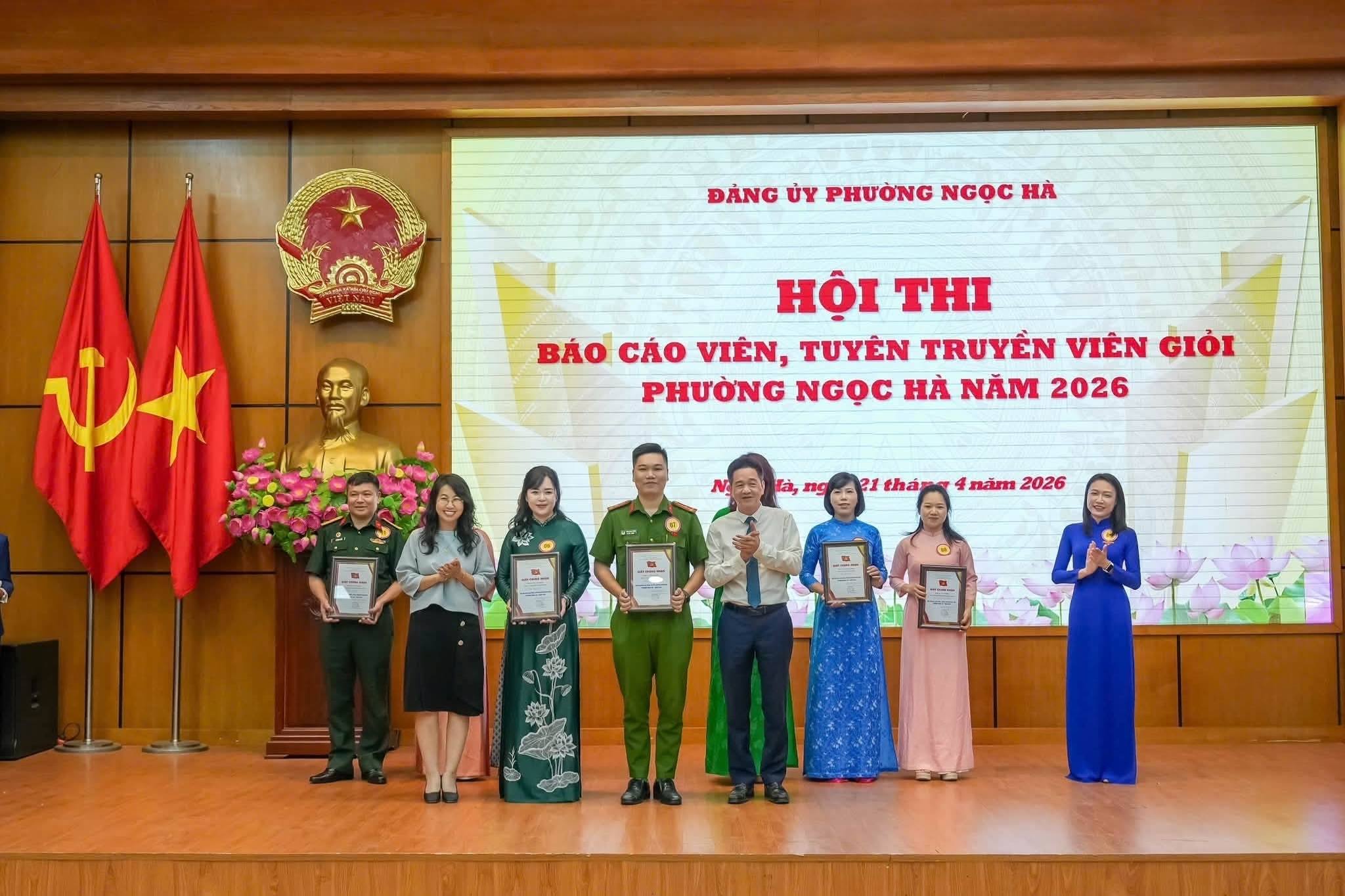 A group of people standing on a stage holding certificatesAI-generated content may be incorrect.