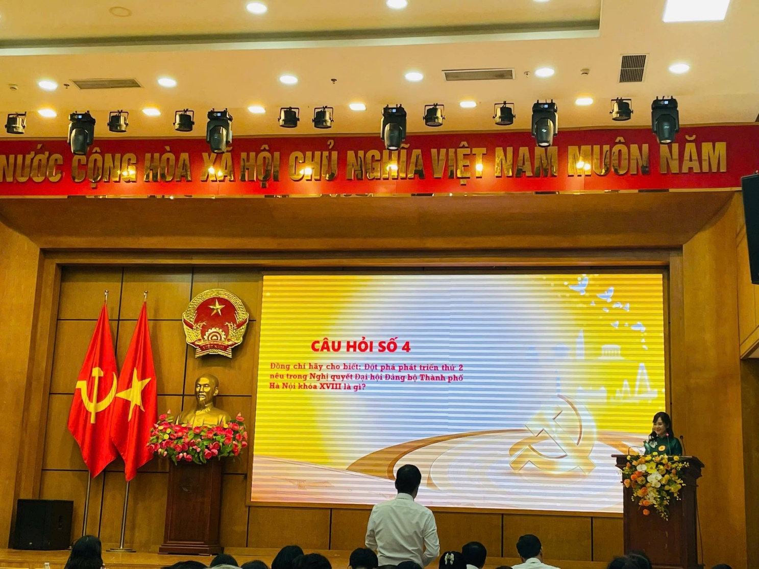 A group of people standing in front of a stageAI-generated content may be incorrect.