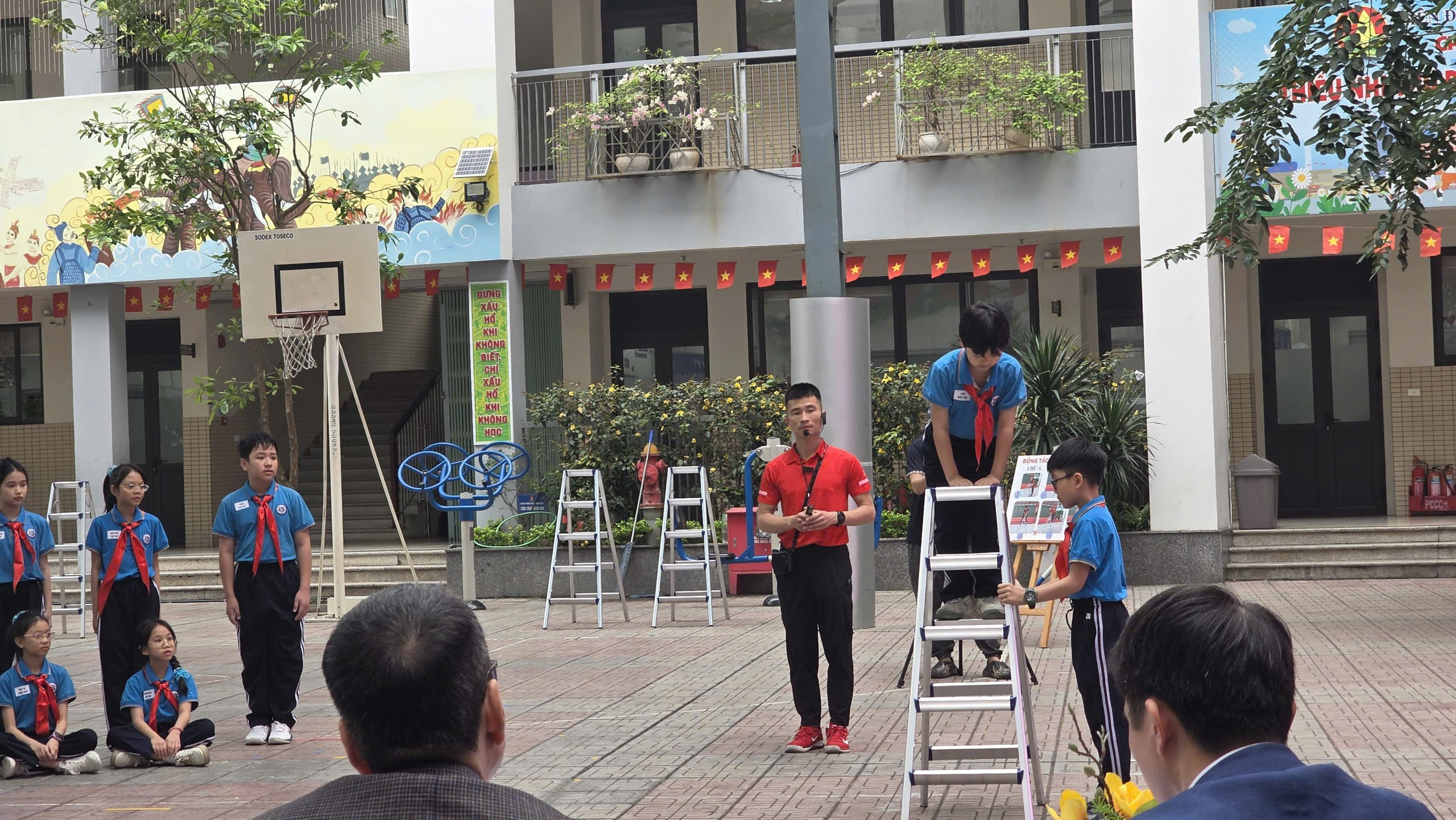 A group of people on ladders outside a buildingAI-generated content may be incorrect.